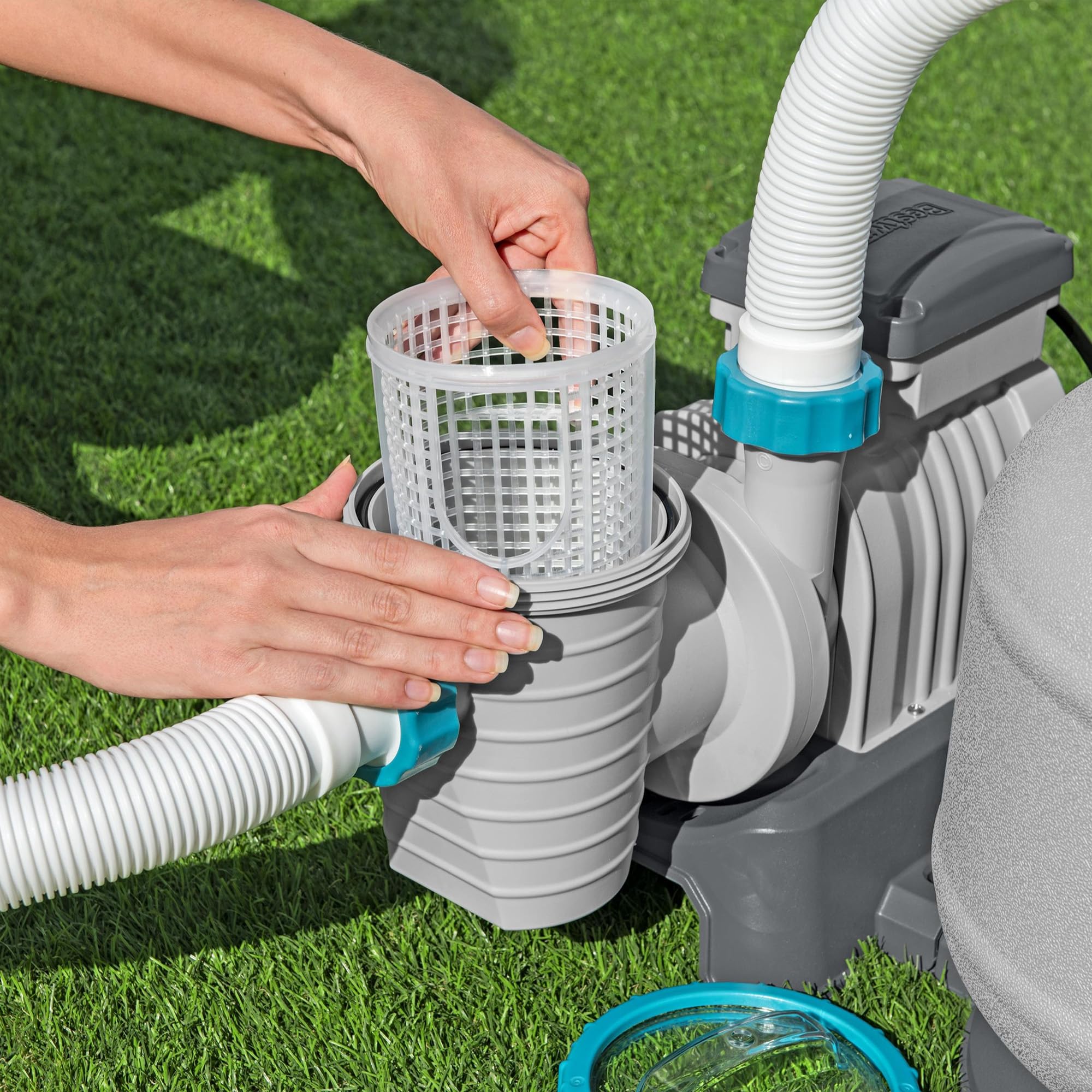 Hands removing the Bestway sand filter pump pre-filter strainer basket