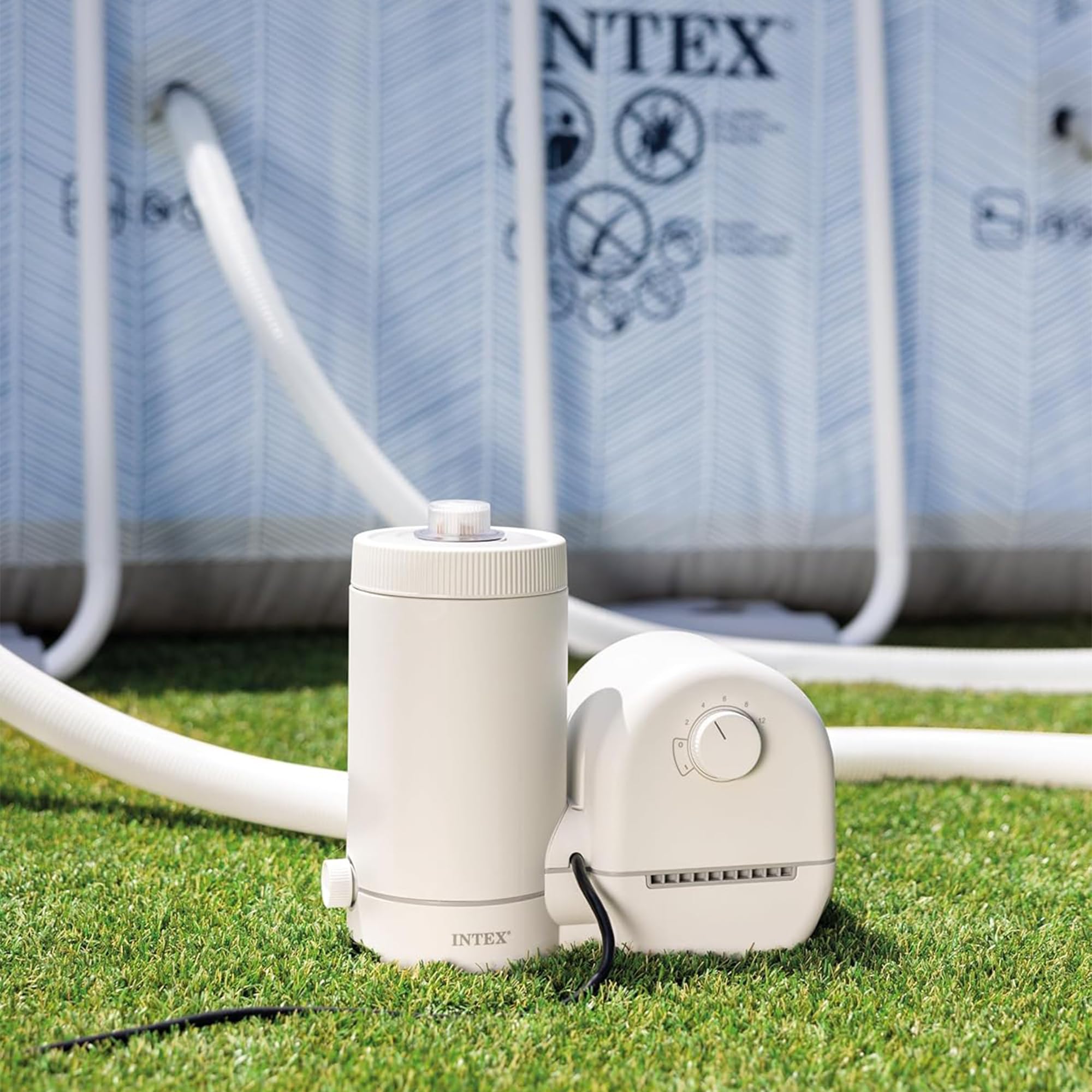 Intex C1500 pump and filter canister set up on grass beside an above-ground pool